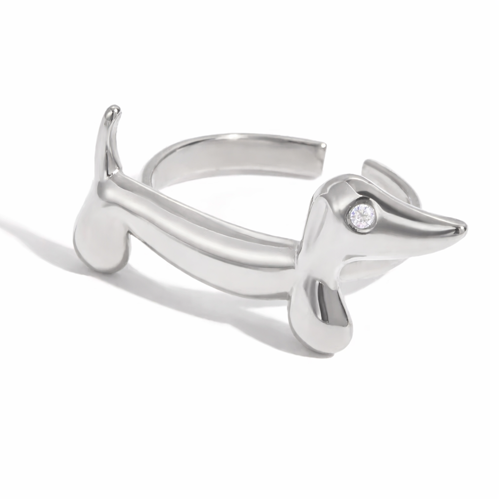Silver dachshund-shaped ring on a white background