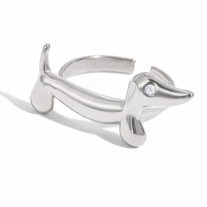 Silver dachshund-shaped ring on a white background