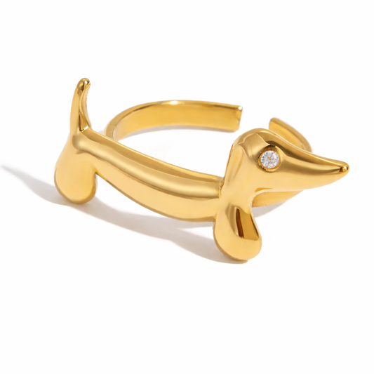 Gold dog-shaped ring with a diamond on a white background