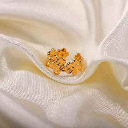 Gold floral ring on a white fabric background