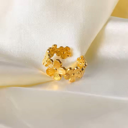 Gold floral ring on a white fabric background