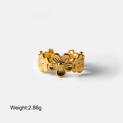 Gold floral ring on a white background with weight displayed