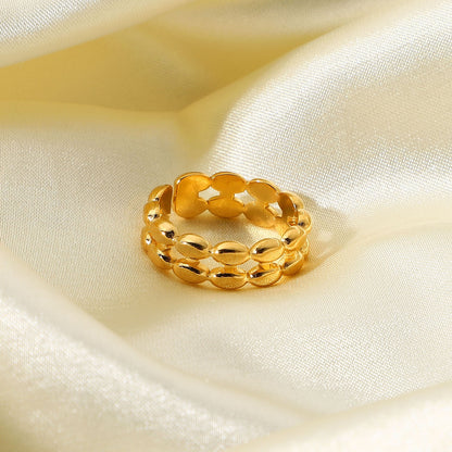 Gold tarnish-free ring on a soft beige fabric background