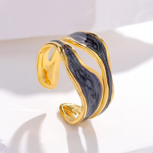 Gold and black marbled ring on a light background