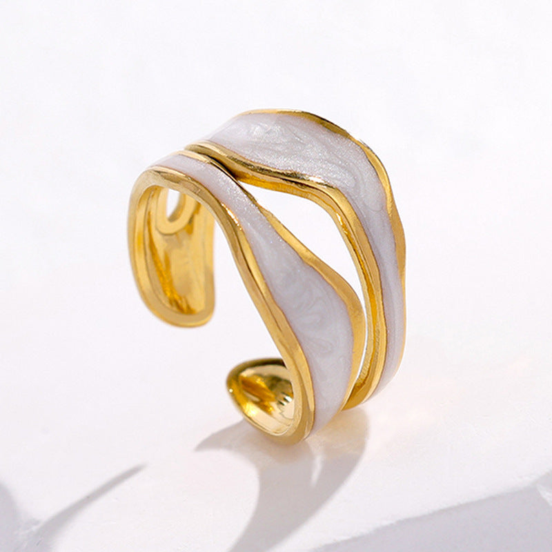 Gold and white waterproof ring on a light gray background