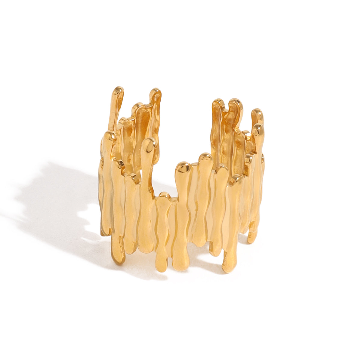 Gold ring with wavy design on a white background