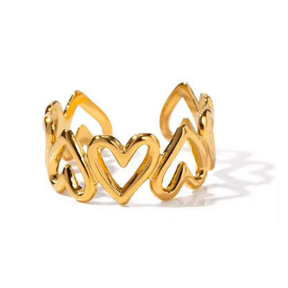 Gold ring with heart design on a white background