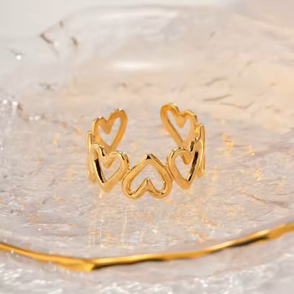 Gold heart-shaped ring on a reflective surface