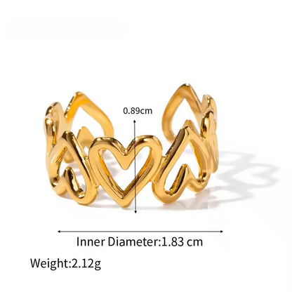 Gold heart-shaped ring with measurements on a white background