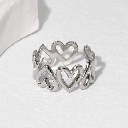 silver heart shaped ring on a white background