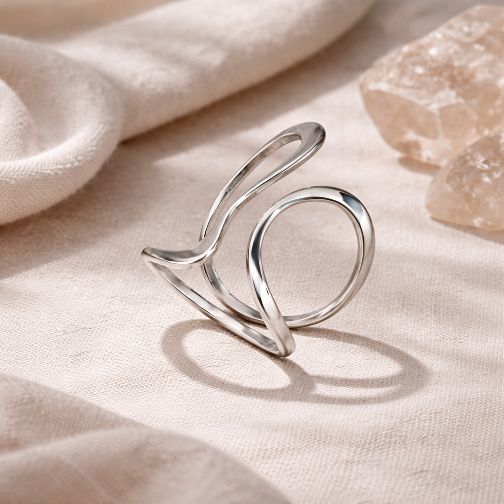 Elegant silver ring on a soft beige fabric background