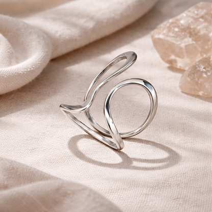 Elegant silver ring on a soft beige fabric background