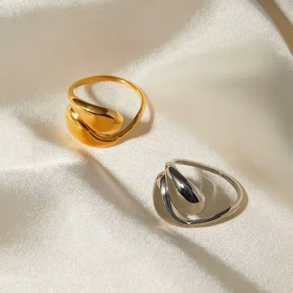 Gold and silver rings on a textured white surface