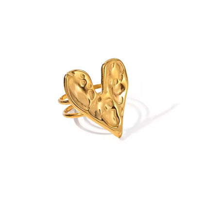 Gold heart-shaped ring on a white background