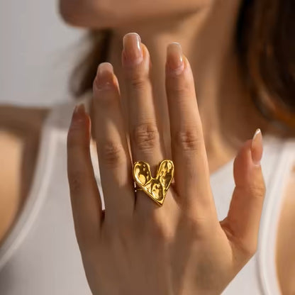 Gold ring on a person's finger with a blurred background