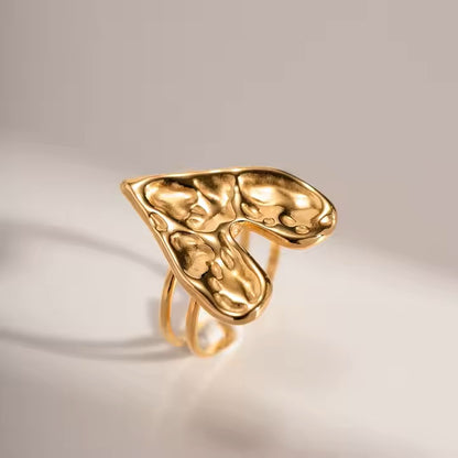 Gold ring with a unique design on a light background