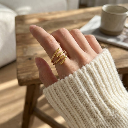 person's hand with gold waterproof ring