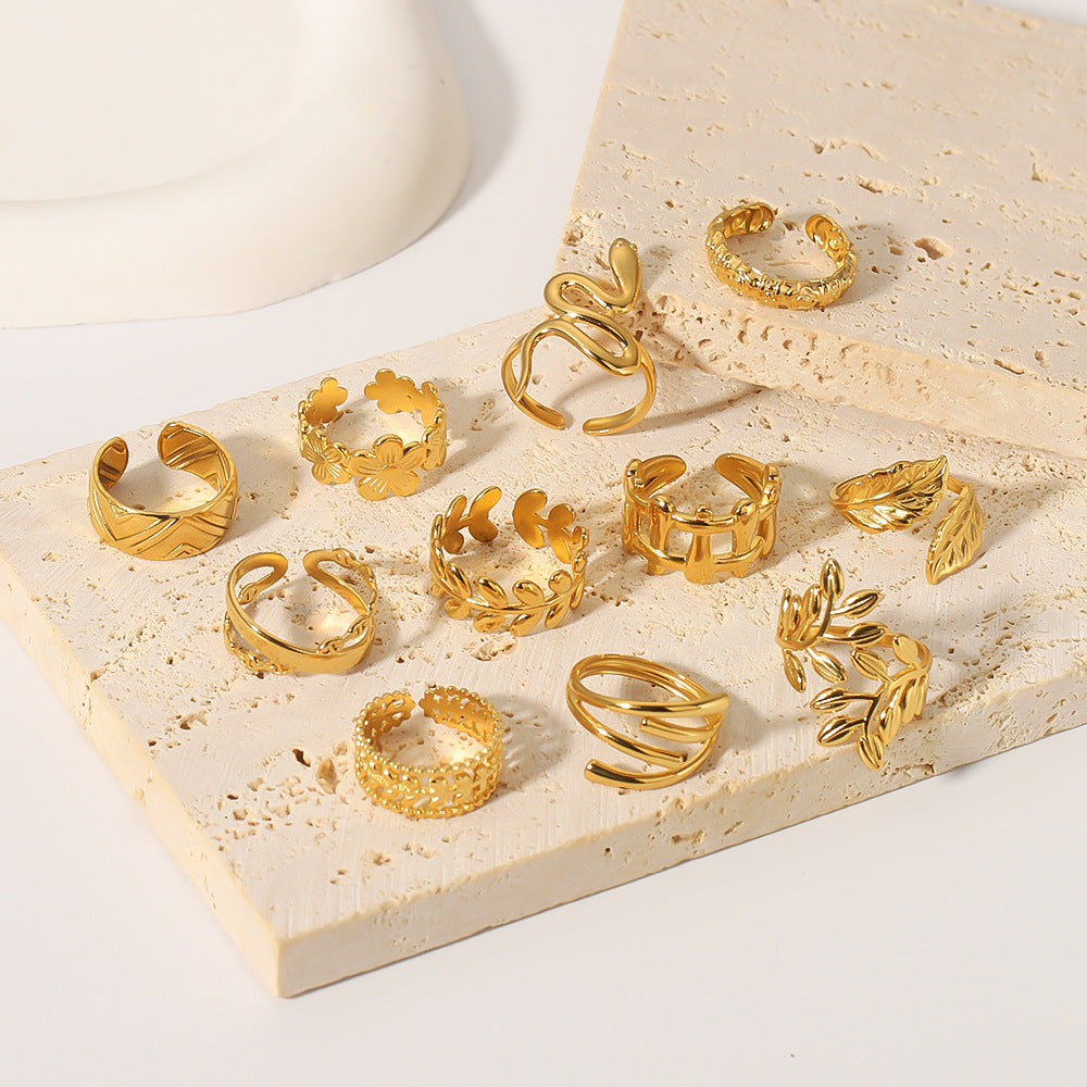 multiple gold rings on beige background