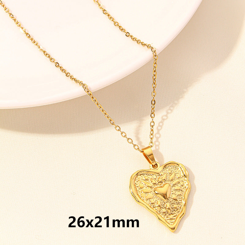 Gold waterproof heart-shaped pendant necklace on a light background