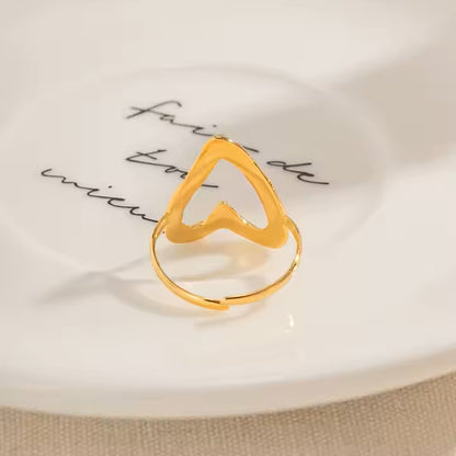 Gold ring with a unique design on a white surface