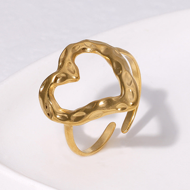 Gold ring with a textured design on a white background