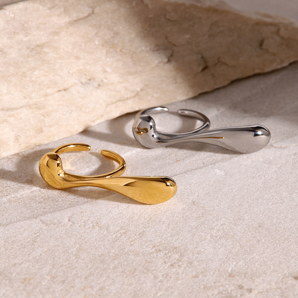 two chunky double rings, one in gold, another in silver color
