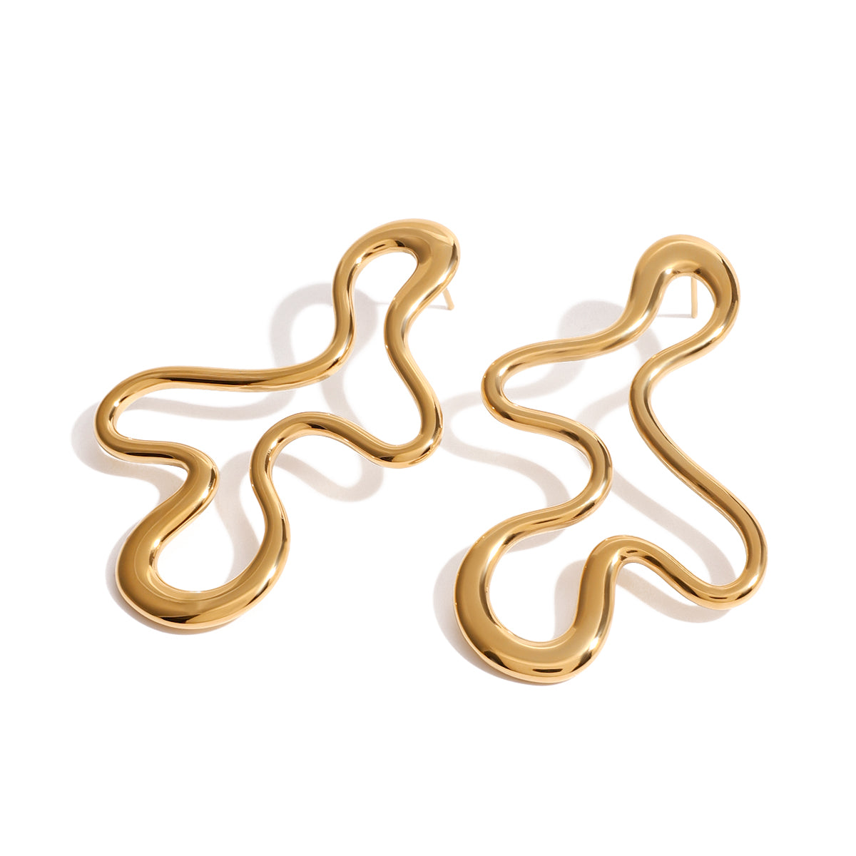 Gold abstract earrings on a white background