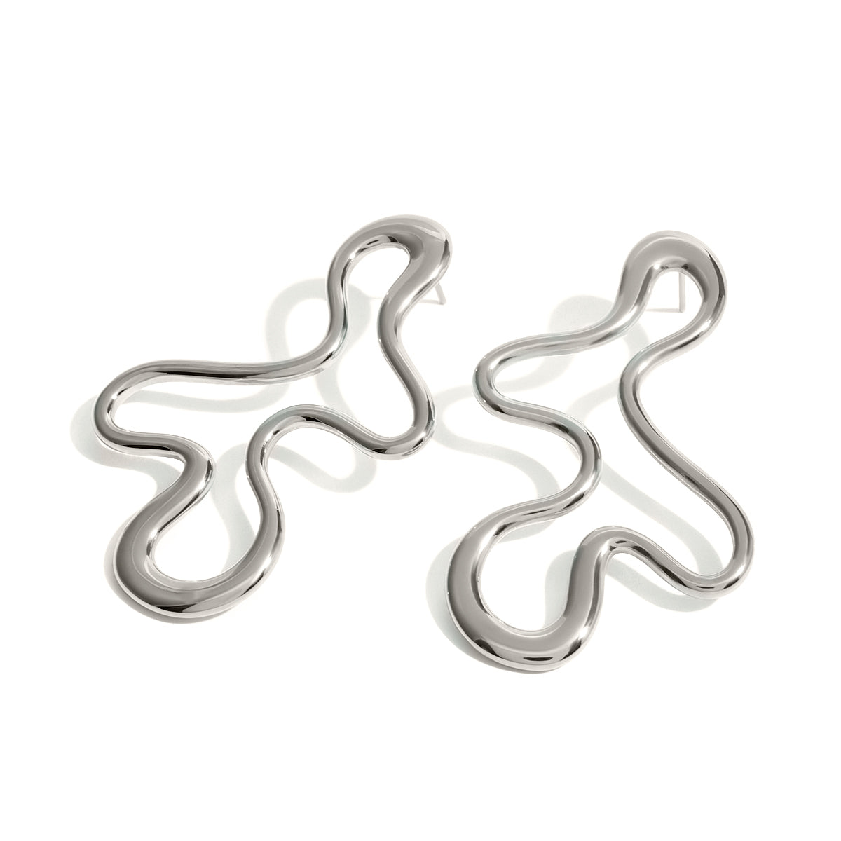 Pair of silver earrings with wavy design on a white background