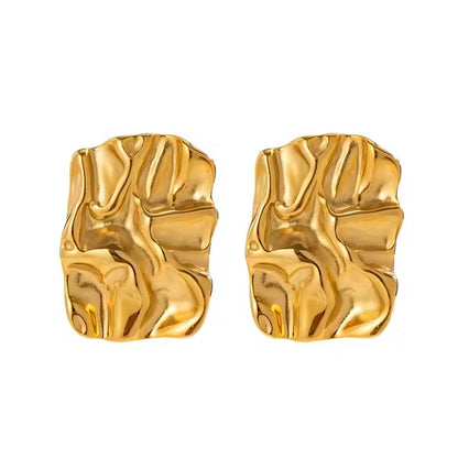 Pair of gold stainless steel earrings on a white background