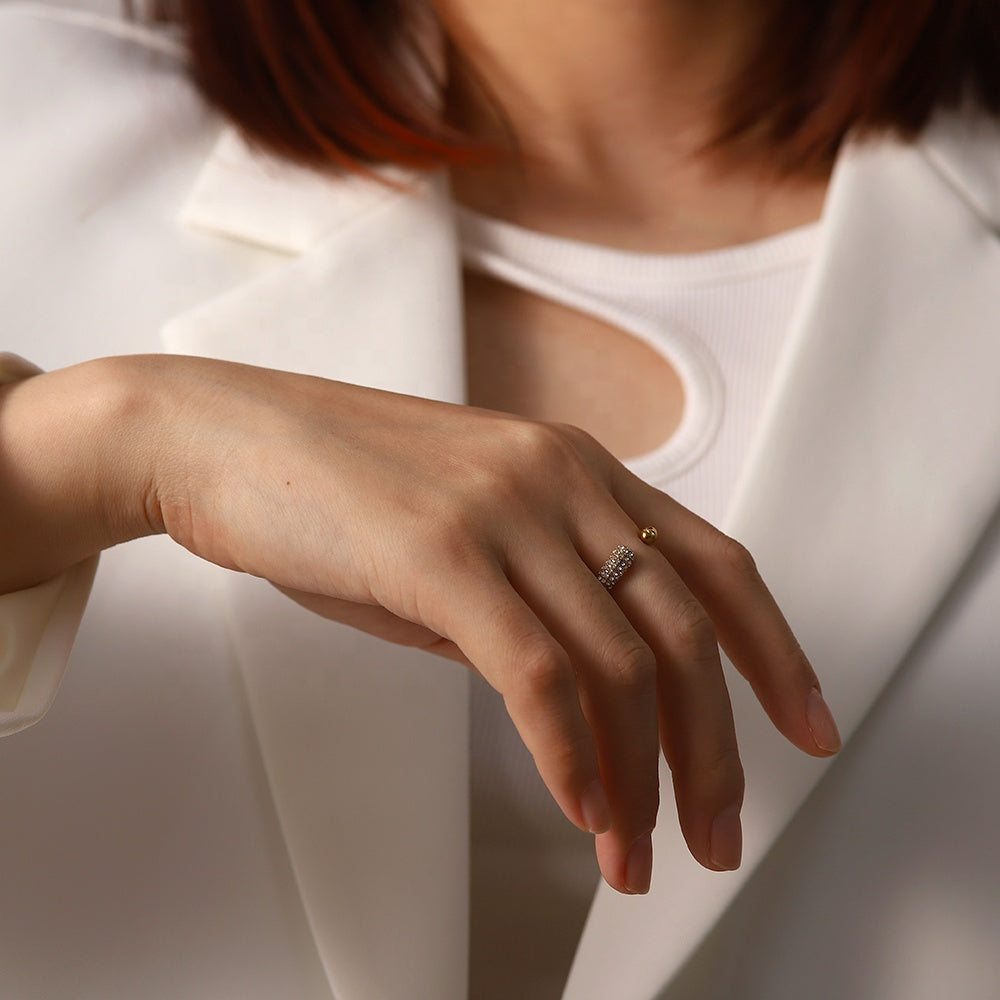 hand wearing elegant gold ring with zircons 