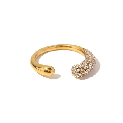 Gold open ring with a diamond-studded end on a white background