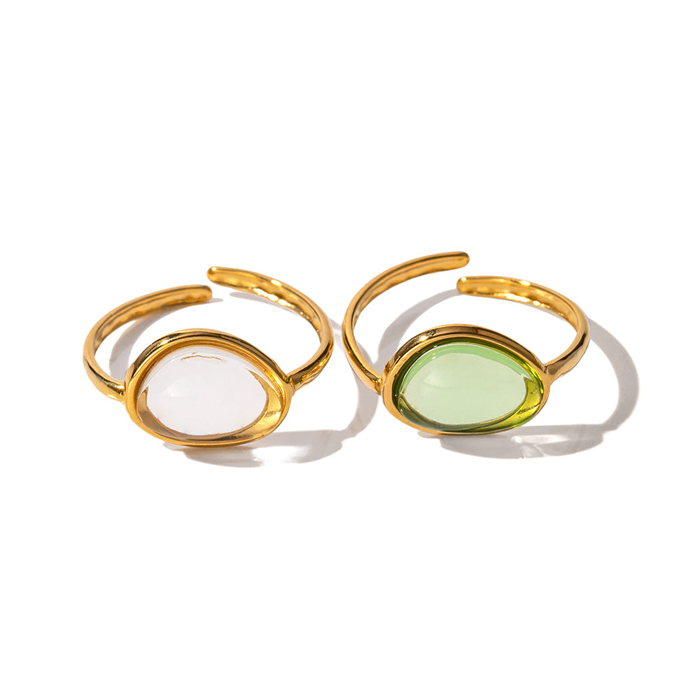 Two gold-framed ring with gemstones on a white background
