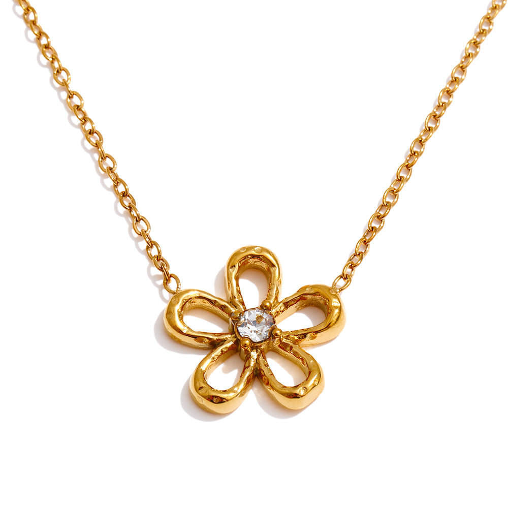 Gold necklace with a flower-shaped pendant on a white background