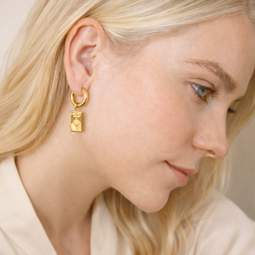 woman wearing unique design gold stainless steel earrings