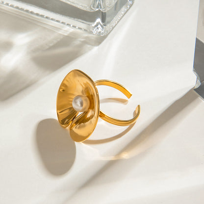 Gold chunky ring with a pearl on a white surface