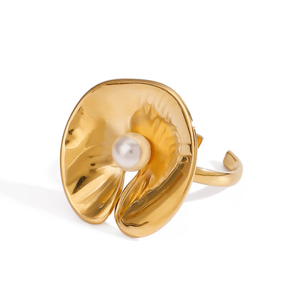 Gold ring with a pearl center on a white background