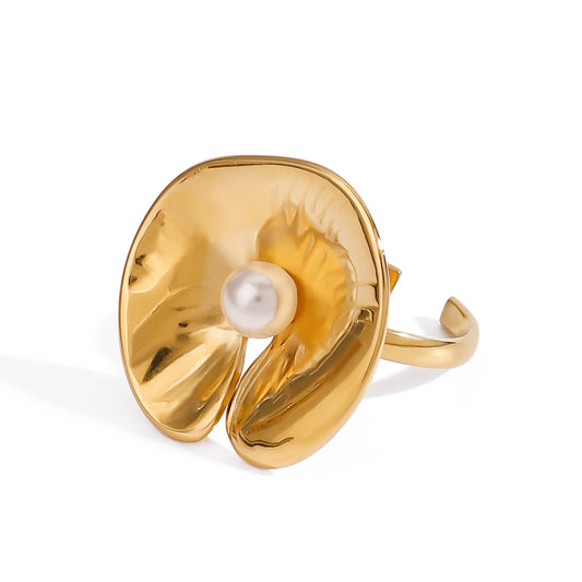 Gold ring with a pearl center on a white background