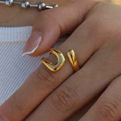 Gold ring on a person's finger with a blurred background