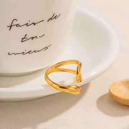 Gold ring on a white saucer with cursive text