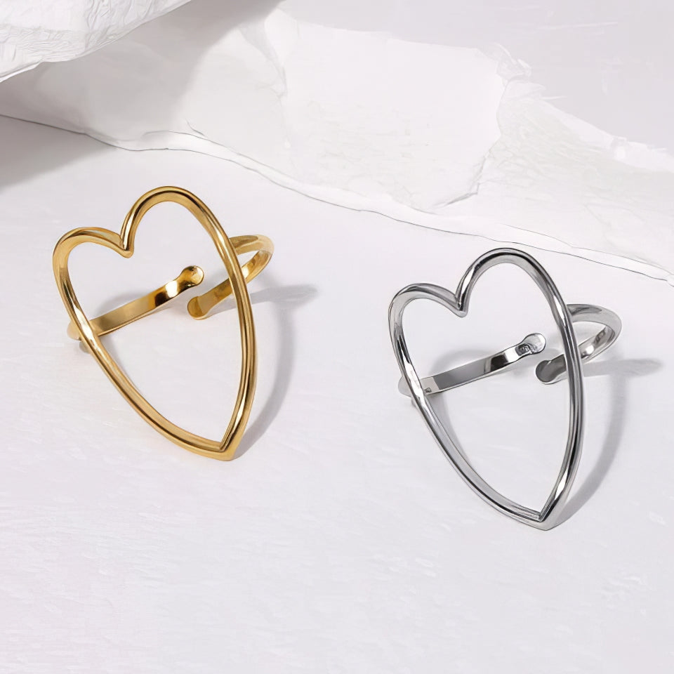 Gold and silver heart-shaped rings on a white background