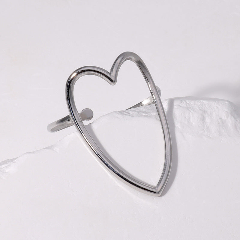 Silver heart-shaped earring on a light gray background