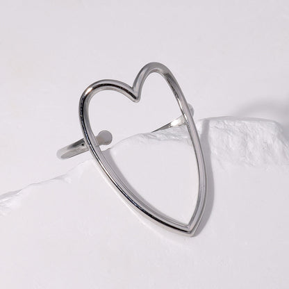 Silver heart-shaped earring on a light gray background