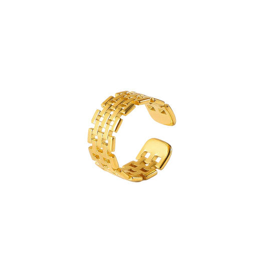 Gold stainless steel ring on a light gray background