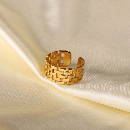 Gold waterproof ring on a beige fabric background