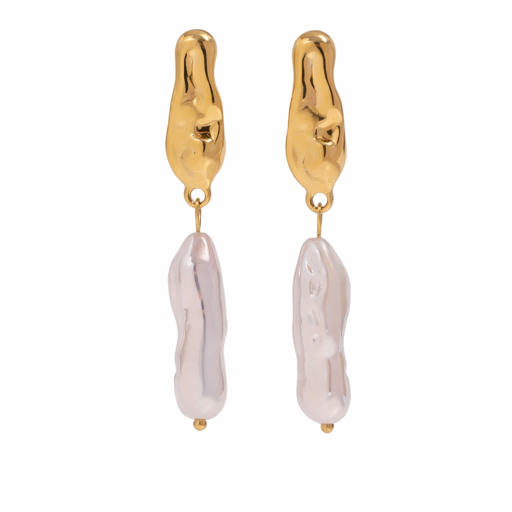 Gold dangly earrings with white pearl drops on a white background