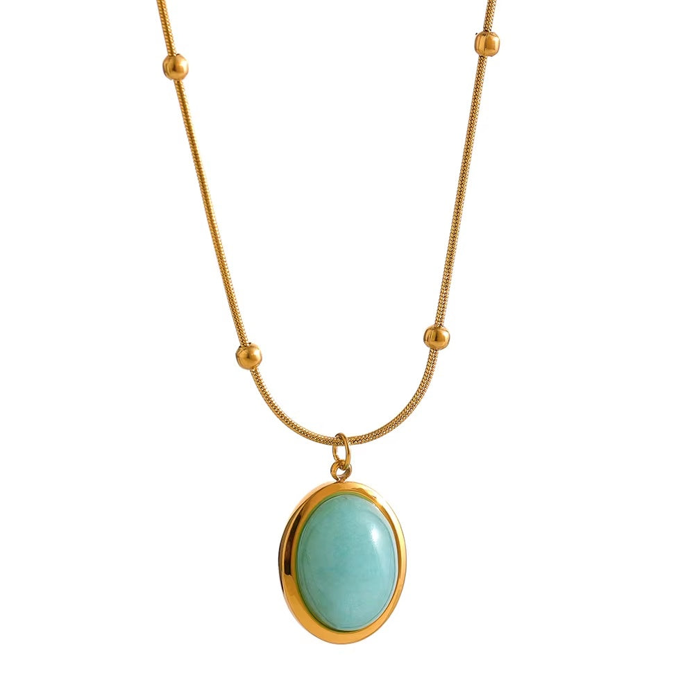 Necklace with a gold chain and turquoise pendant on a white background