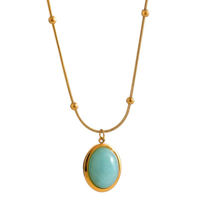 Necklace with a gold chain and turquoise pendant on a white background