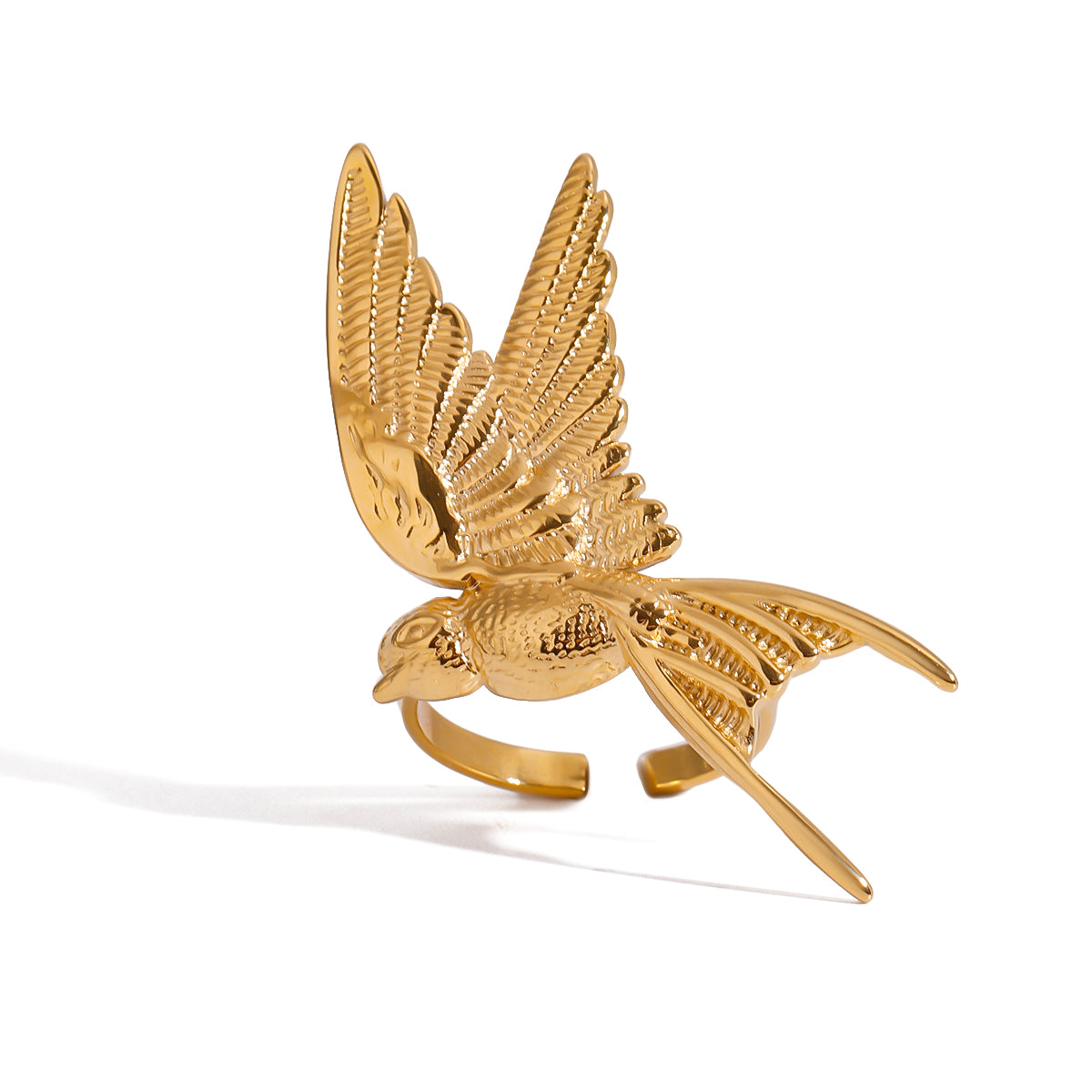 Gold bird-shaped ring on a white background