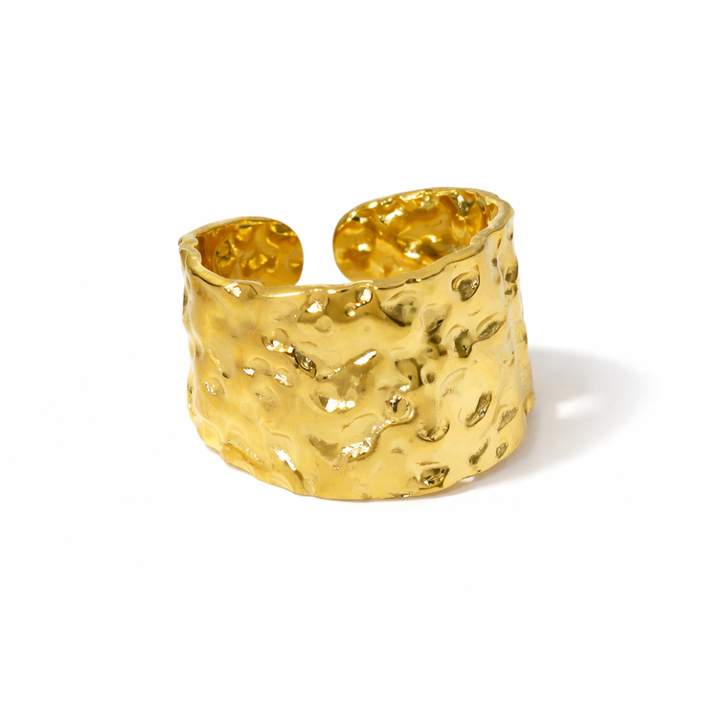 large Gold textured ring on a white background