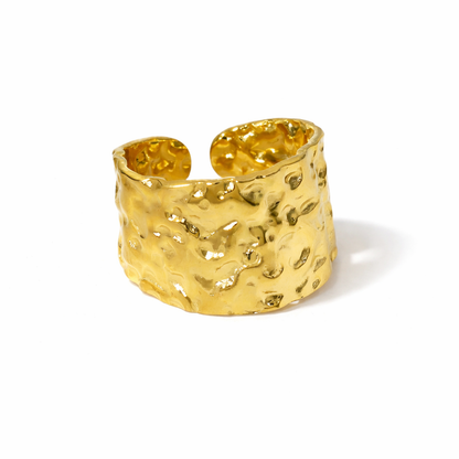 large Gold textured ring on a white background